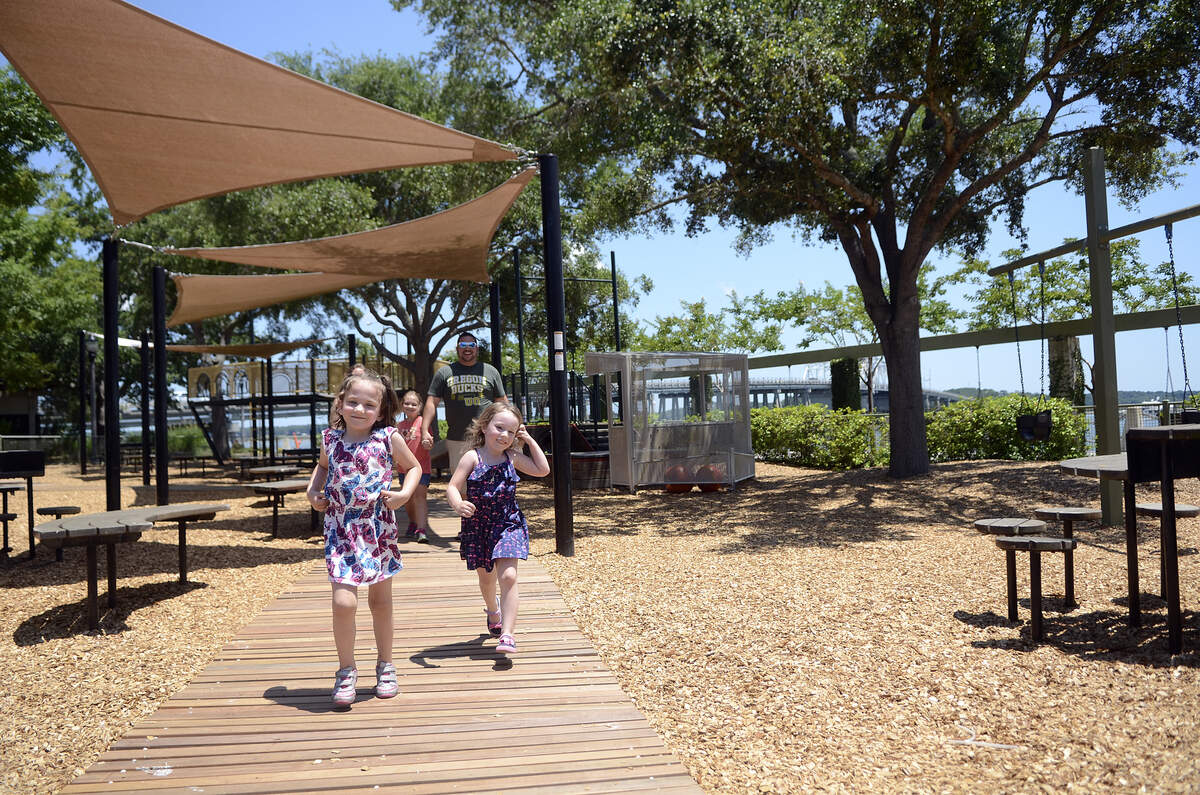 Annalise Edwards, 5, left, of Beaufort, and Violet Chaffin, 4, of Turner, Ore. run along the newly installed handicapped accessible walkway at the playground at Henry C. Chambers Waterfront Park on a Tuesday afternoon in 2014 in Beaufort.