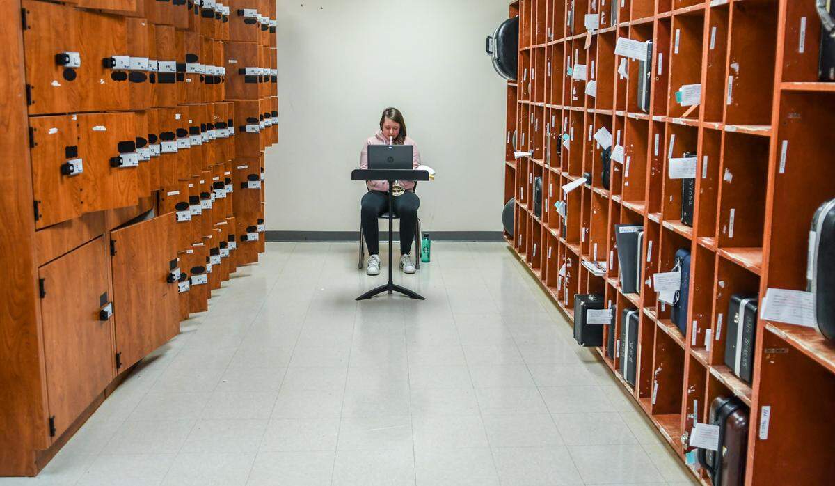 Chloe Clark, an eighth grade student at Beaufort Middle School, practices her new trumpet on Monday, Oct. 5, 2020 on the first day of in-person instruction. Chloe chose the equipment room to remain socially distanced from four other music students as Amanda Trimpey, instrumental music director, worked with in-person and virtual students. The Beaufort County School District is developing hybrid models of in-person instruction to keep staff and students safe from the spread of the coronavirus.