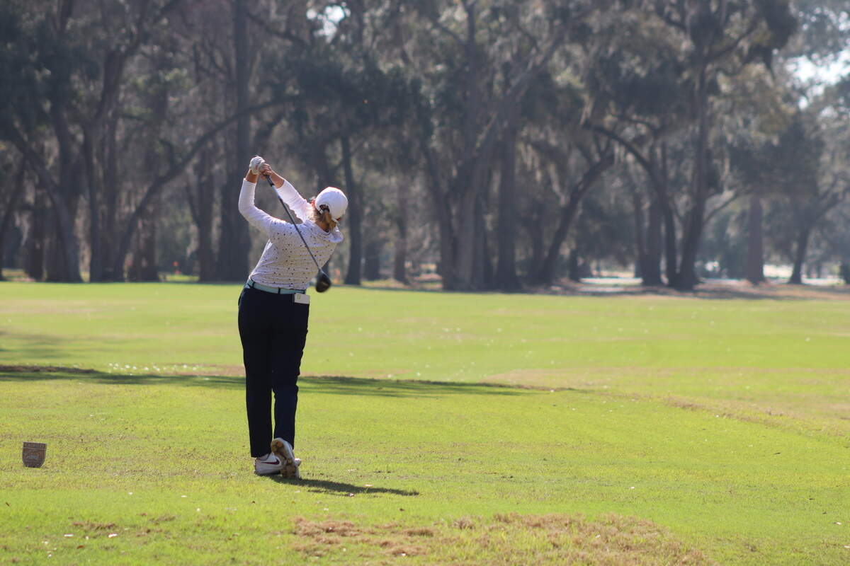 Golfer hitting with a driver