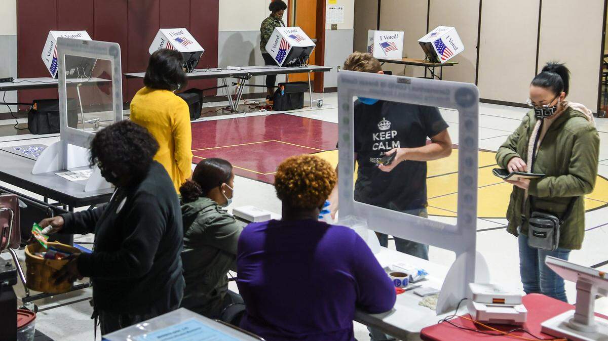 Poll workers help voters in the general election on Tuesday, Nov. 3, 2020 at Shanklin Elementary School in Seabrook.