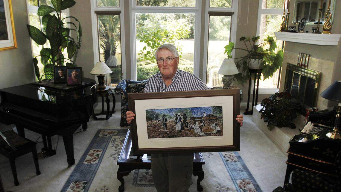 Chris Clayton, of Hilton Head Island, holds one of his paintings from a new series of work in his living room on  September 3, 2014.  Clayton uses antebellum black and white photographs, sketches, and historical clippings from old newspapers to create pastel images of historical events.  This painting was portrayed in color using an old photograph taken close to Hilton Head Plantation. His latest exhibition will be on display at the Art League of Hilton Head beginning Sep. 11.