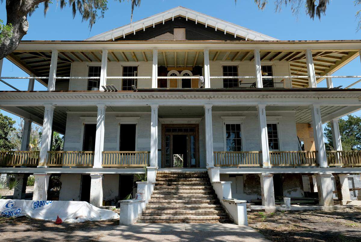 The front entrance to Tidalholm as seen on Thursday morning as work continues on the second-floor porch. A narrow staircase on the second floor leads to the gabled roof where a former cupola or belvedere remains after the second floor had a porch and railing added with a joined roof line.