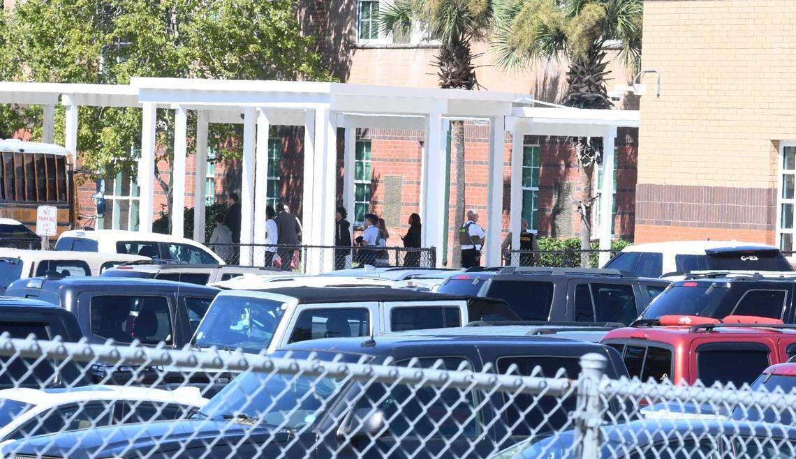 Students are loaded onto buses Wednesday after hoax threats were called in at Beaufort High School.