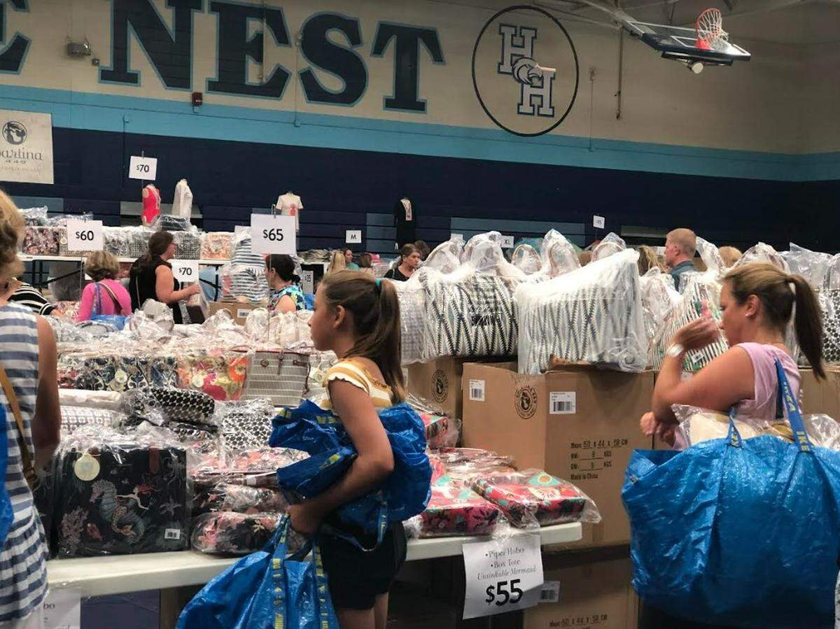 Shoppers walk among tables of discounted merchandise at the 2022 Spartina 449 Warehouse Sale on Hilton Head Island.