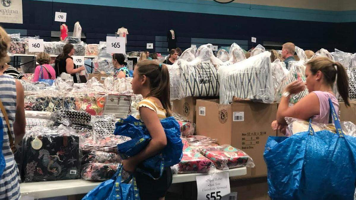Shoppers walk among tables of discounted merchandise at the 2022 Spartina 449 Warehouse Sale on Hilton Head Island.