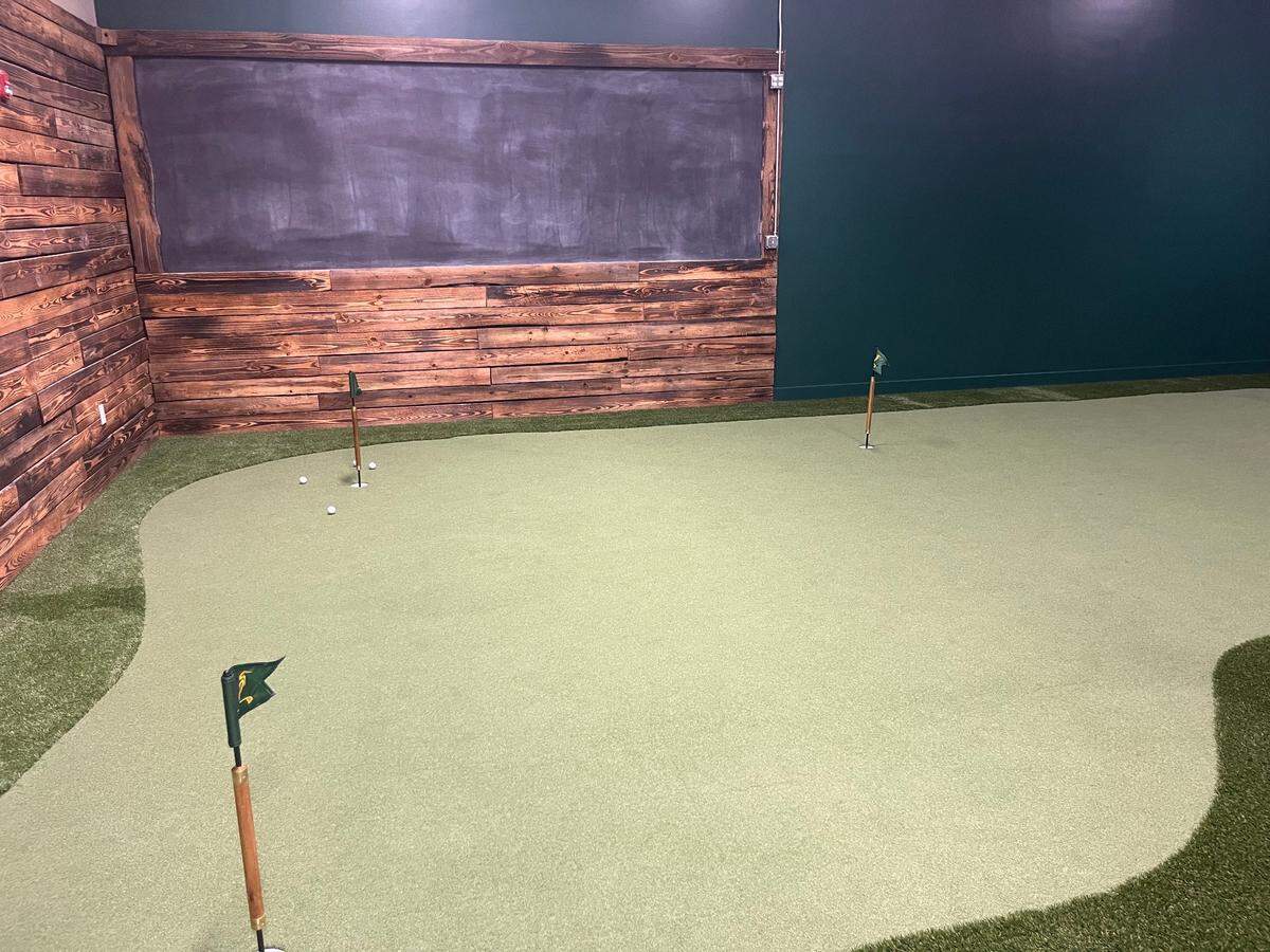 Egret and Iron has four golf simulator bays in addition to a putting green and chipping area.