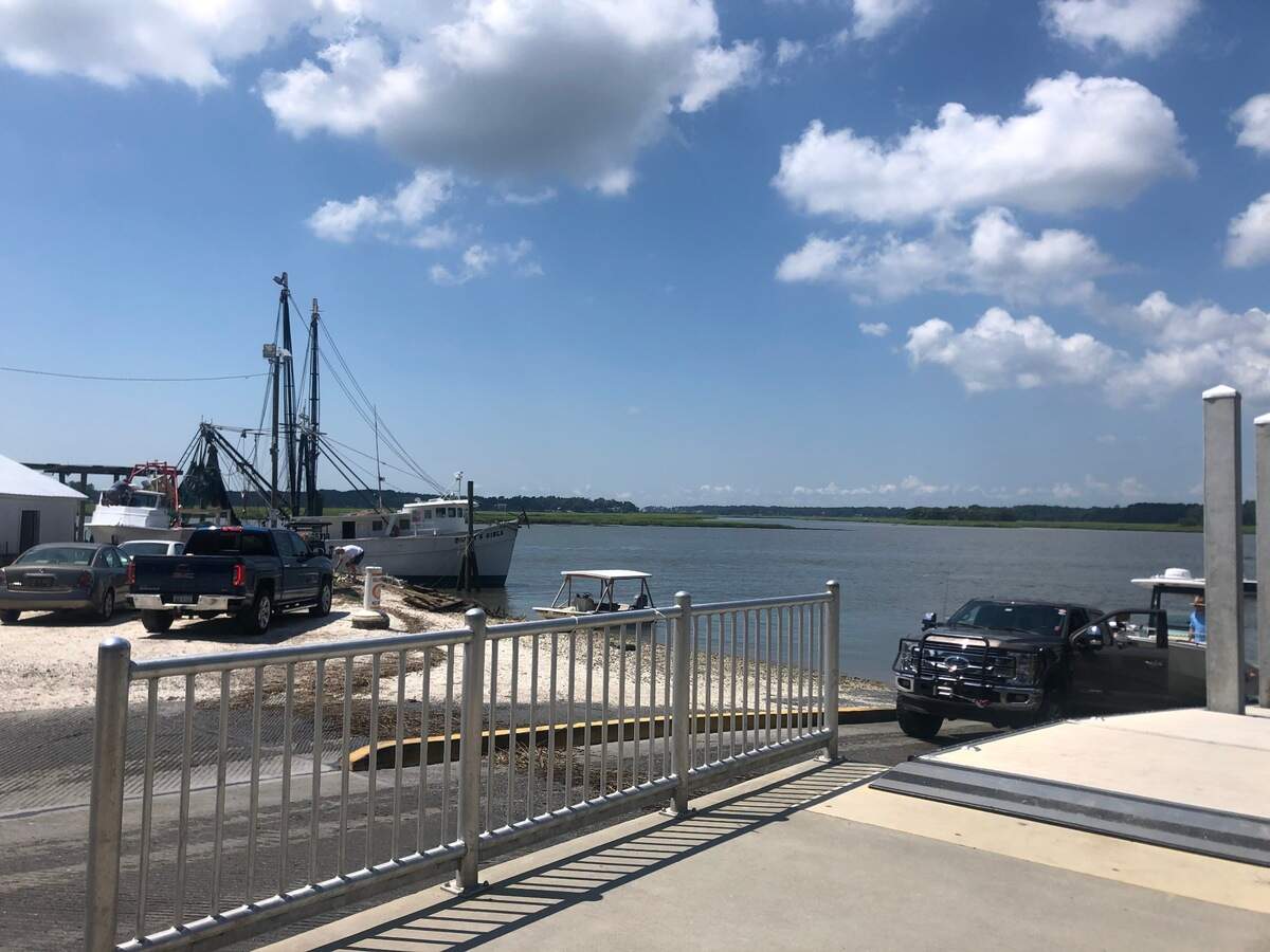 The Bluffton Oyster Factory boat ramp photographed on July 3, 2020. Trucks hauling boat trailers make y-turns at the landing and then back trailers into the May River.