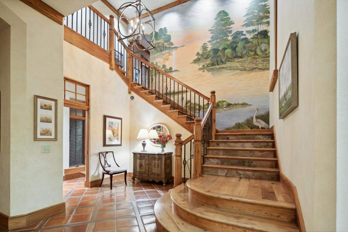 A view of the staircase and accompanying mural found within 30 Oyster Shell Lane on Hilton Head Island, SC.