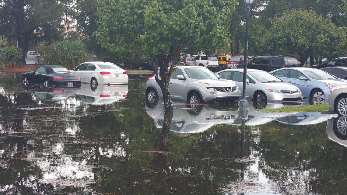 About a dozen cars in the Moss Creek Village parking lot in Bluffton flooded or were in danger of flooding Aug. 27, 2015, following a powerful thunderstorm.