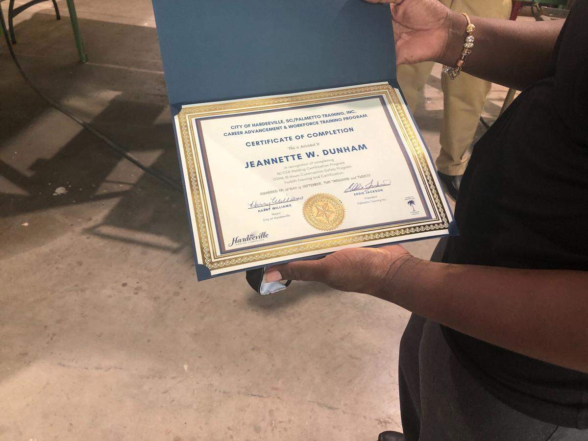 Jeannette Dunham, a graduate of Hardeeville’s workforce training program, holds her certificate of completion for a welding, forklift driving and occupational safety course.