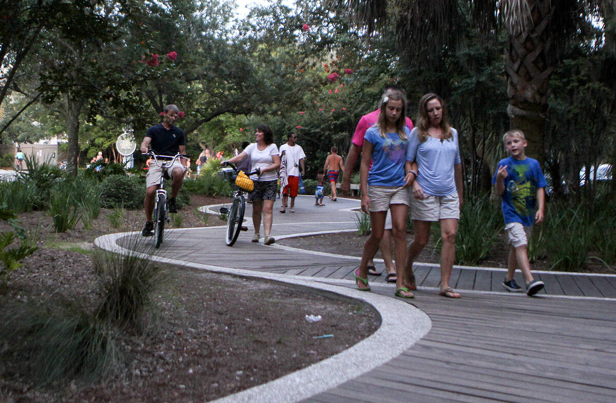 In this file photo, tourists walk along the main boardwalk at Coligny Beach Park on Hilton Head Island. The Town of Hilton Head is considering an 8 p.m. curfew for juveniles in response to a recent shooting that stemmed from an argument between two groups of teenagers on Coligny Beach.