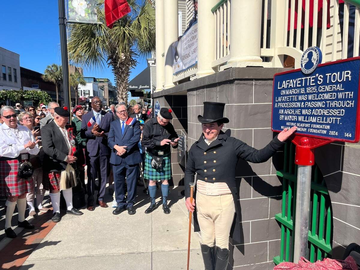 Marquise de Lafayette, played by historical interpreter Mark Schneider, stands by a sign honoring the American Revolutionary war hero from France. The sign was unveiled during Lafayette’s return to Beaufort Tuesday, the 200-year anniversary of his 1825 visit to the city.