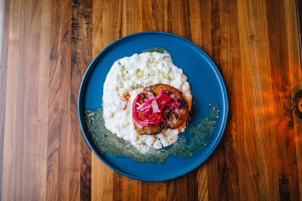 Haitian griot with hominy from Okan Bluffton