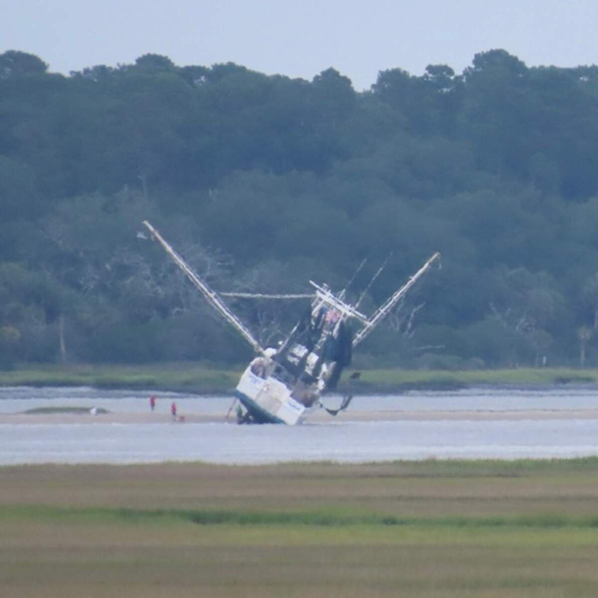 Repairs are done on a shrimp boat during low tide on the Morgan River this week.