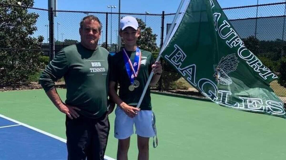 Beaufort eighth grader Graeme Angus, right, poses for a photo with coach David Riedmayer after Angus won the SC Class 4A/5A boys singles tennis tournament on Tuesday at Florence Tennis Center.