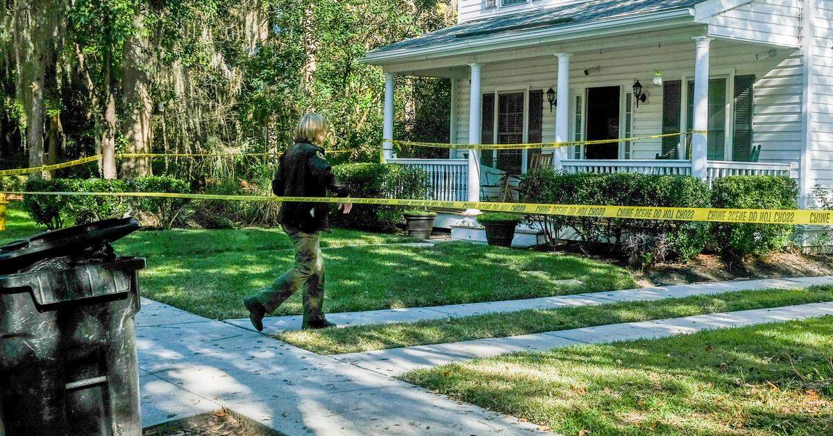 Security cameras cover the entrance of the home as a deputy with the Beaufort County Sheriff’s Office walks under the police tape on Tuesday, Nov. 17, 2020 at a homicide investigation in the gated-community of Westbury Park in Bluffton. Police responded to the neighborhood on Monday night after receiving a call of shots fired and found 45-year-old Timothy Milliken dead. As police were working inside the home on Tuesday, a deputy turned away a garbage man from emptying the receptacle, foreground, outside of Milliken’s home.