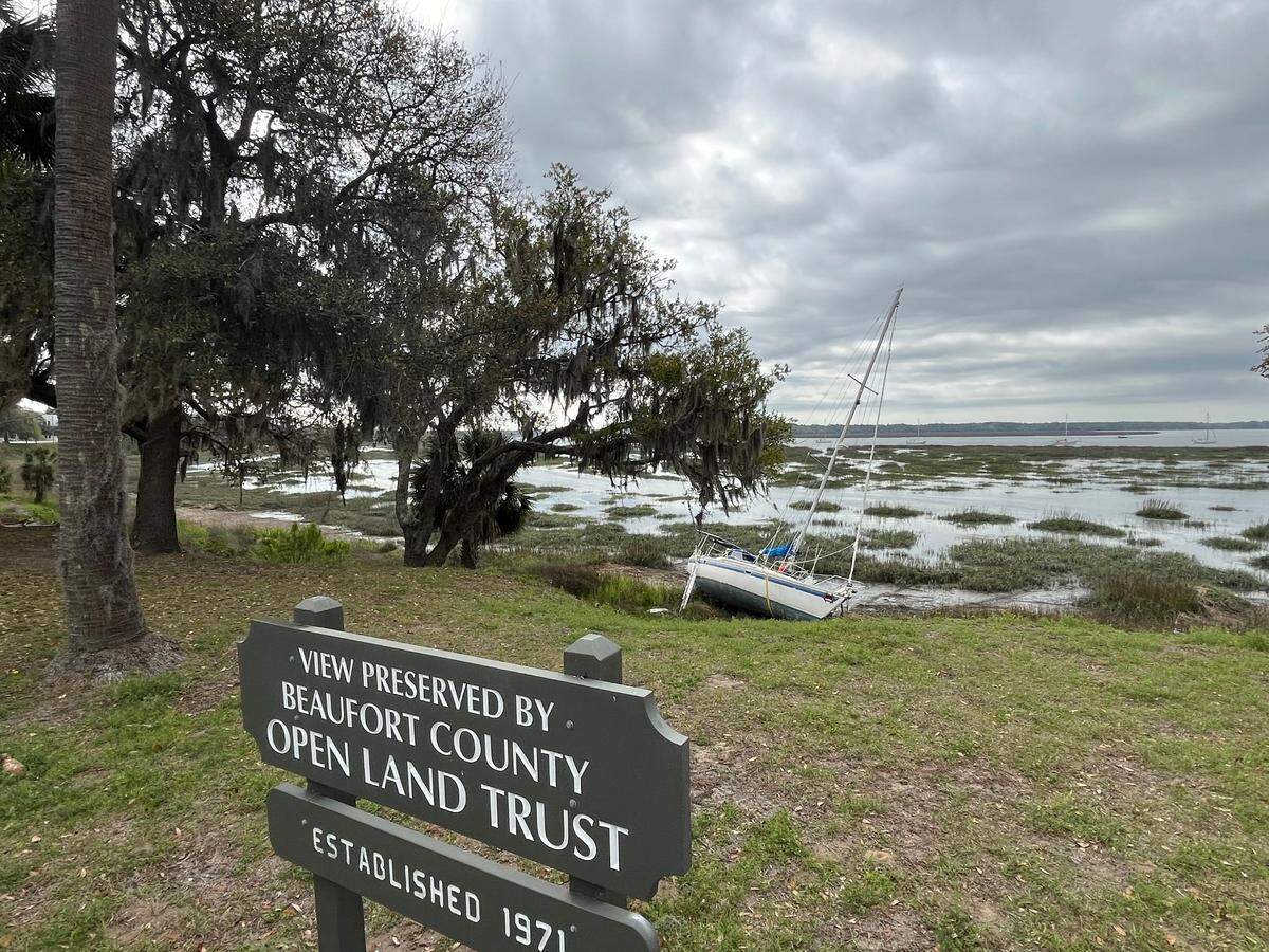 The view of the Beaufort River from Bay Street in Beaufort has included grounded boats since September, when high winds from Tropical Storm Helene tore them away from city’s marina.