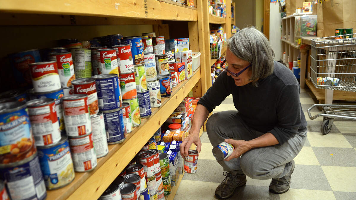 Susan Boyd, a volunteer with The Deep Well Project, organizes donated canned goods in their food pantry on Tuesday afternoon on Hilton Head Island.
