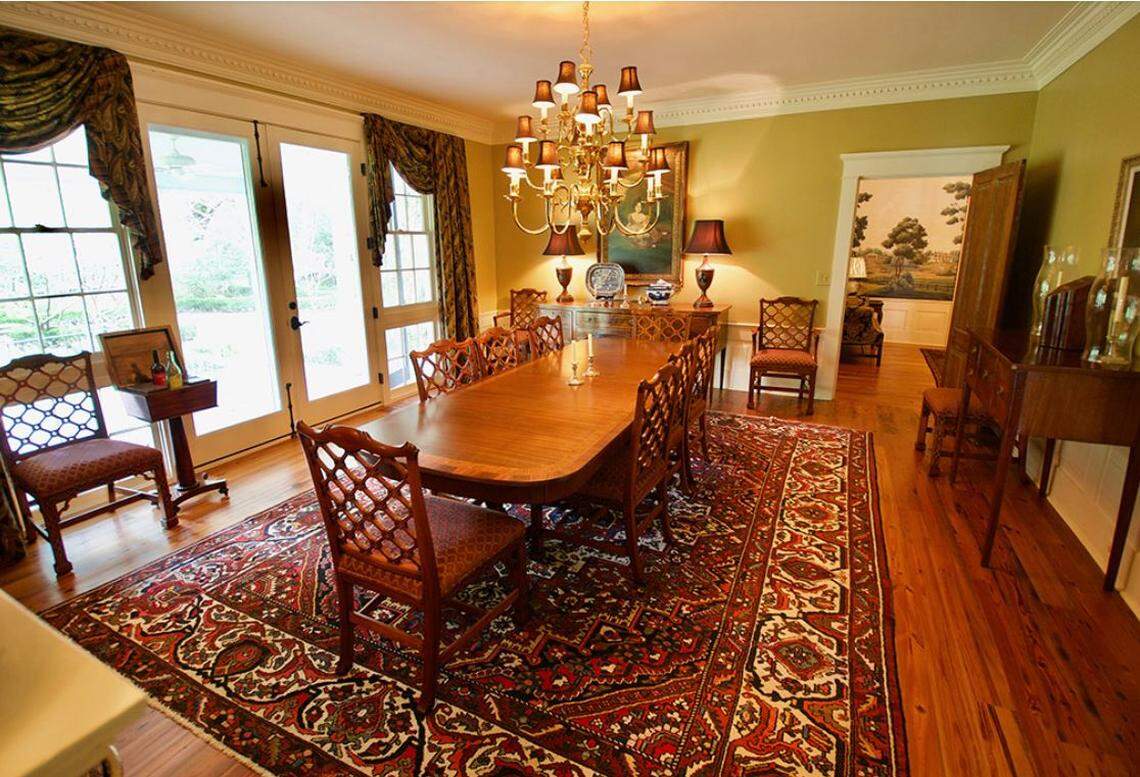 The dining room looks out onto formal gardens.