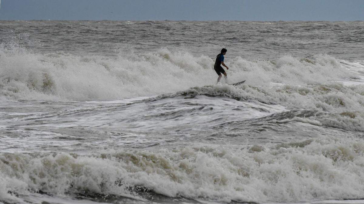 Hilton Head Island resident Scout Stephens, 19, got into the surf on Oct. 10, 2024 at high tide at Burkes Beach in hopes of catching some waves from Hurricane Milton.