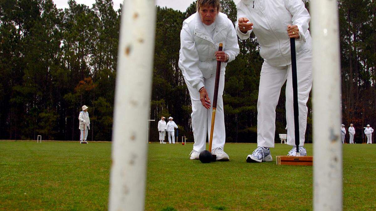 Joanne Foster, right, helps Nancy Easterday plan her next move during a game of croquet Monday morning with the Sun City Croquet Club.