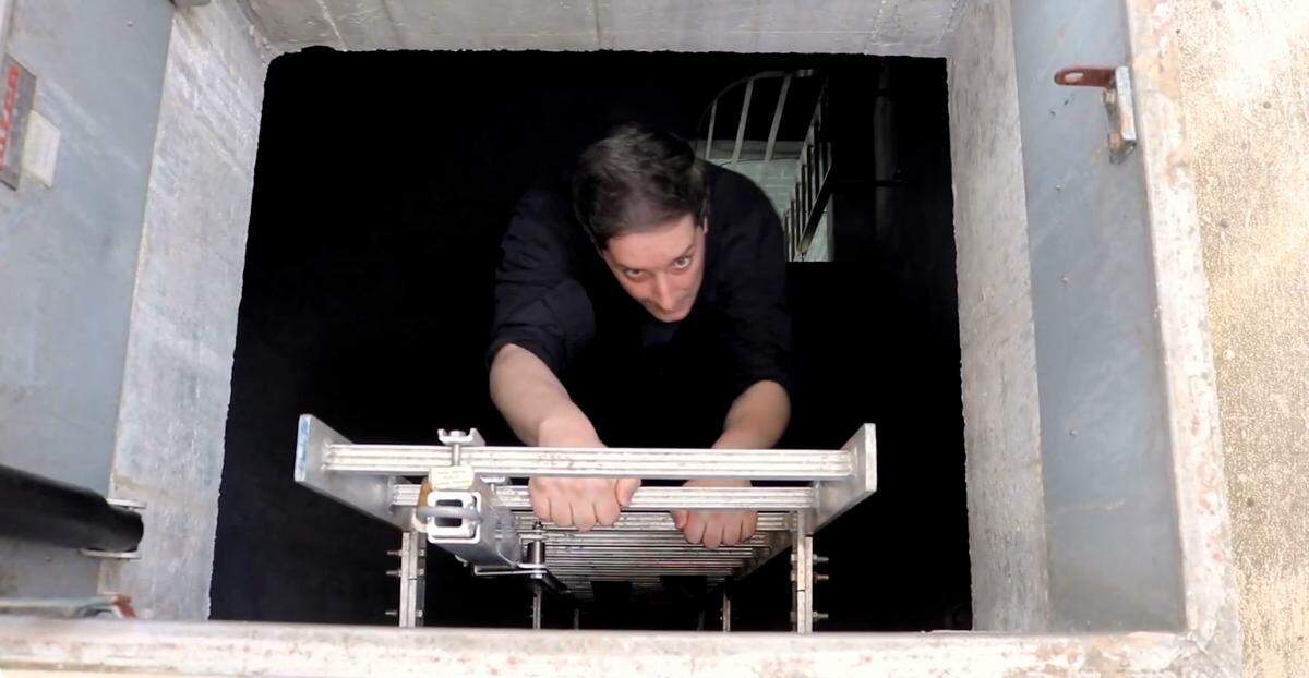 Father Andrew Trapp climbs the final ladder to get to the steeple at St. Peter’s Catholic Church in a video posted in October 2023, on its YouTube page.