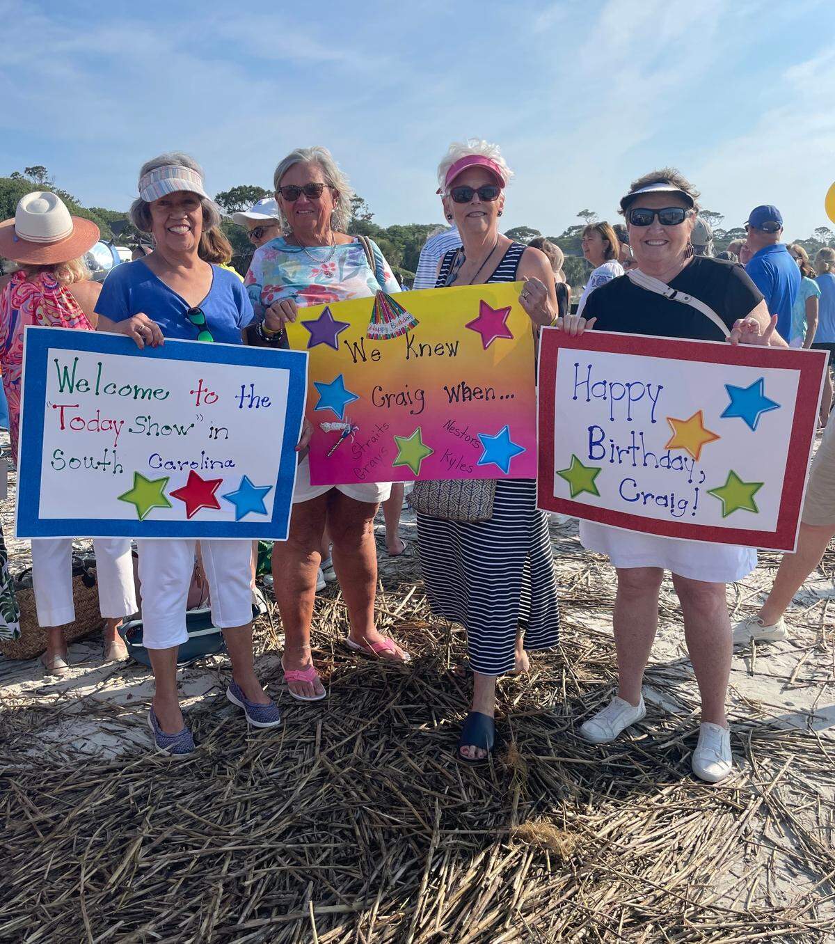 Left to right: Domi Kyle, Lynn Nestor, Hunter Strait, and Nan Gray pose for a picture with their signs.