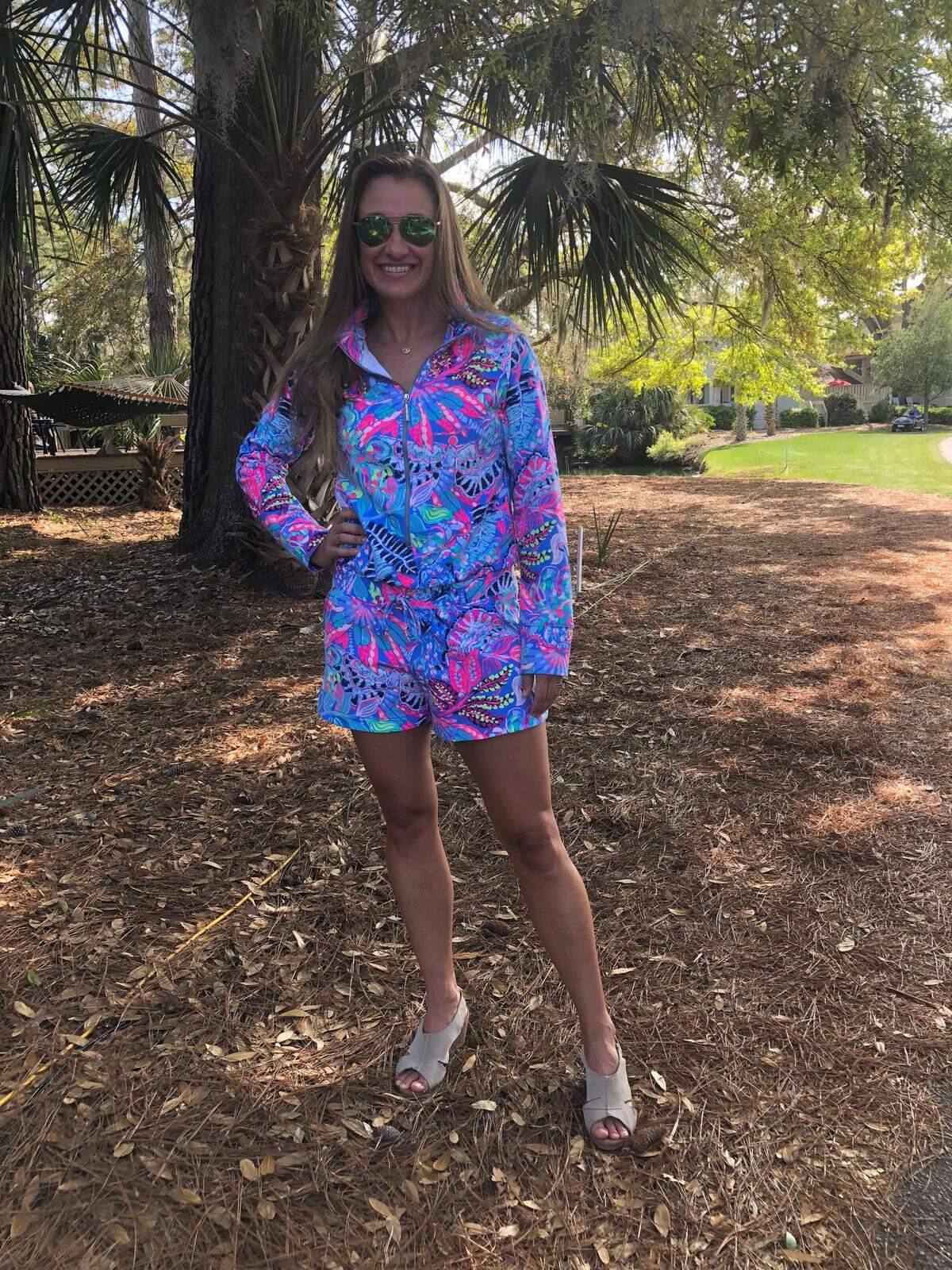 Carridy Bender, of Spartanburg, wears a bright Lily Pulitzer romper at the RBC Heritage Golf Tournament on Friday, April 13, 2018.