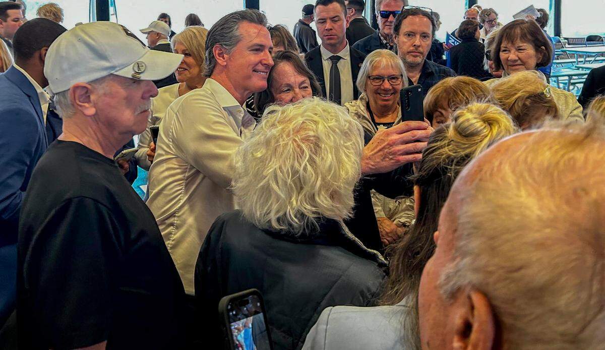 Campaigning for President Joe Biden, California Gov. Gavin Newsom takes a selfie with a supporter on Jan. 24, 2024, at Sun City Hilton Head.