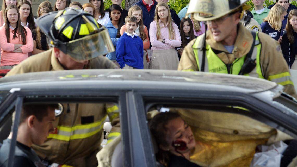 Home-schooled senior Ryon Dimitrov, left, and Beaufort Academy junior Bridget Baggerly, president of Students Against Destructive Decisions Club, right, participate as victims of a drunk driving accident the morning of April 24, 2014, at Beaufort Academy as firefighters with the Lady's Island-St. Helena Fire District extricate the students. The accident, hosted by the academy's SADD chapter, was staged in front of the school body. The Lady's Island-St. Helena Fire District public affairs office helped orchestrate the event along with the Beaufort County Sheriff's Office, S.C. Highway Patrol, Beaufort EMS, Beaufort County Coroner's Office, Gur's Automotive and Medevac Air Ambulance.
