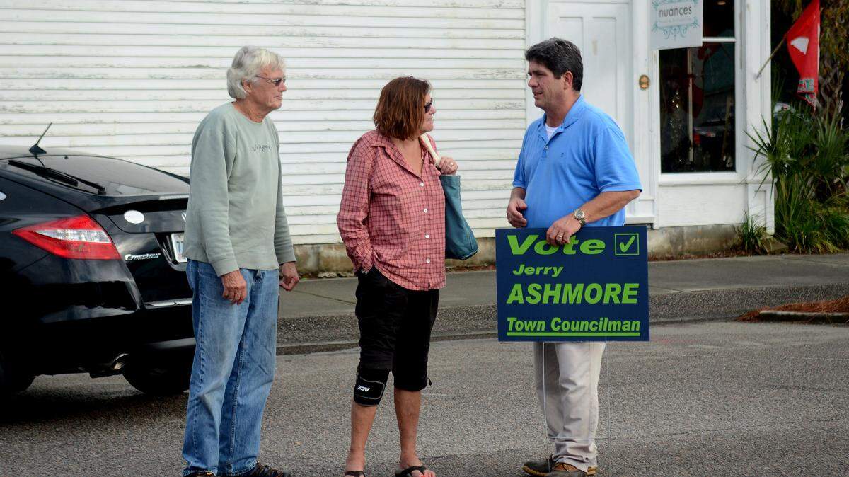 Soon-to-be-elected Port Royal Town Council member Jerry Ashmore, right, talks to Port Royal residents while campaigning near the polling place at the Port Royal Town Hall the afternoon of Nov. 4, 2015, in Port Royal.