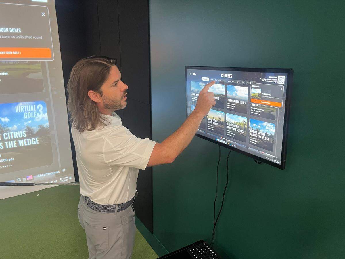 Chad Troutman explains the software at his golf simulator business in Beaufort and how it can be used to transform your swing or transport you to a real golf course.