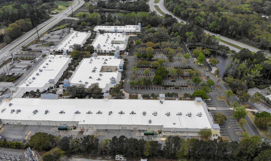A barren parking lot at Tanger Outlets 2 looking west on March 24, 2020, sandwiched between Bluffton Parkway, left, and U.S. 278, right, shows few cars on the usually congested major arteries during the height of the lunch hour. The coronavirus has closed a majority of the national business chains in the area while restaurants compete for carry-out service.