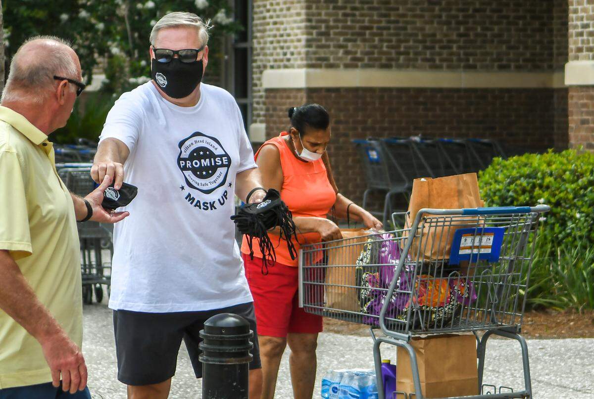 Bill Miles, Hilton Head Island-Bluffton Chamber of Commerce President and CEO, distributes free face coverings on June 27, 2020 at the Kroger at Shelter Cove Towne Centre on Hilton Head Island.