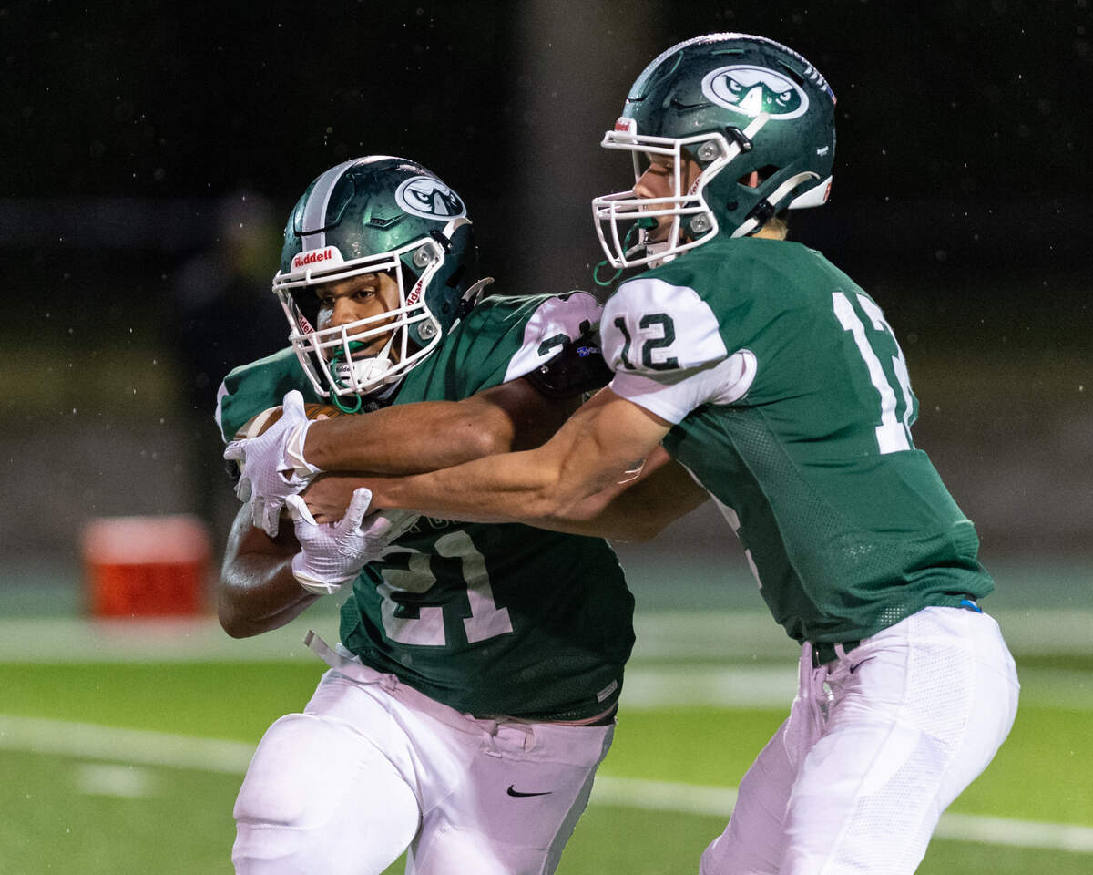 Beaufort High School’s Amariee Morris takes a handoff from Tyler Haley as the Seahawks dominated South Florence in a 30-14 victory on Friday, Nov. 5, 2021.