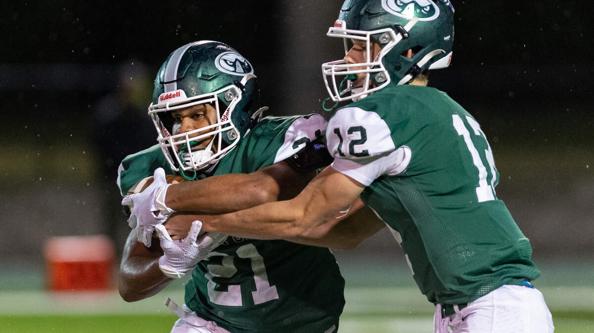 Beaufort High School’s Amariee Morris takes a handoff from Tyler Haley as the Seahawks dominated South Florence in a 30-14 victory on Friday, Nov. 5, 2021.