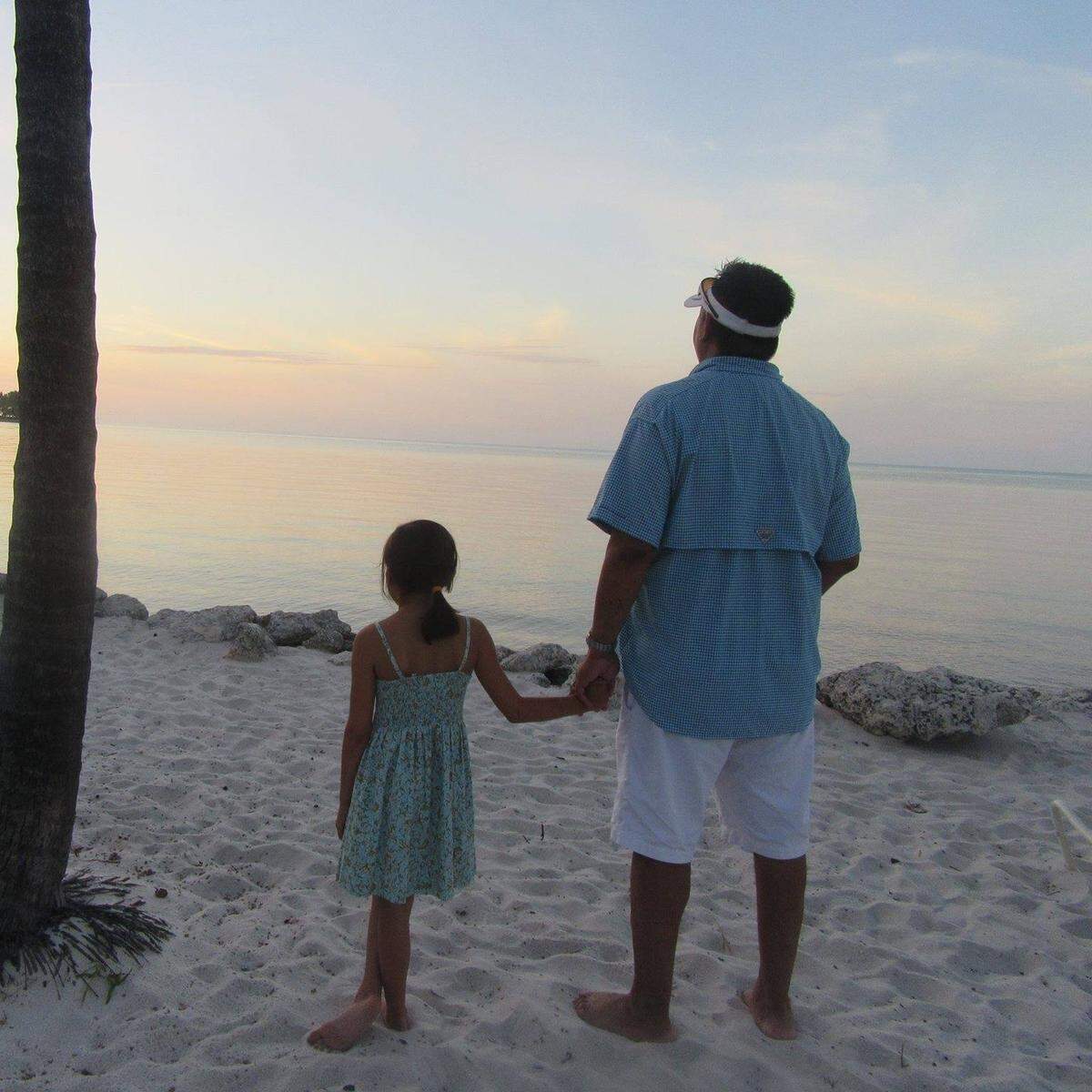 Dakota Harris and her dad, Austin, watch the sunset together. Austin died Dec. 17, 2020 at just 46 years old.