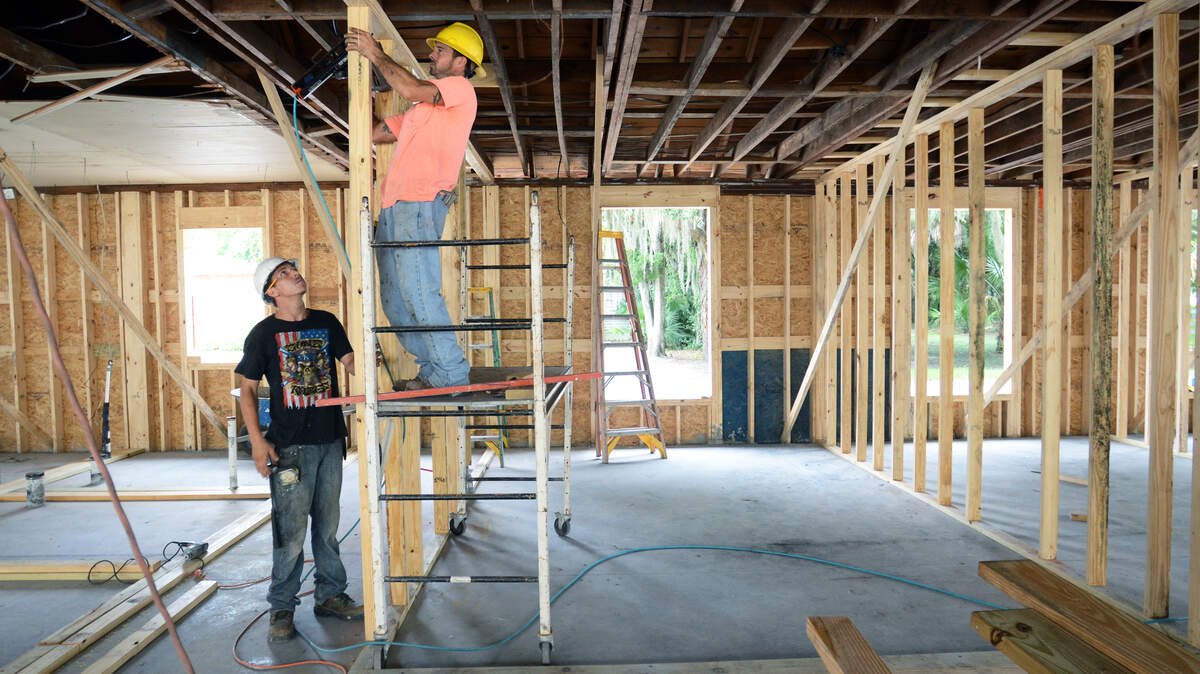 Terry Long, left, and Jason Sullivan put up an interior wall as restoration work on the historic Von Harten Bros. building along Carteret Street continues Sept. 16, 2015.