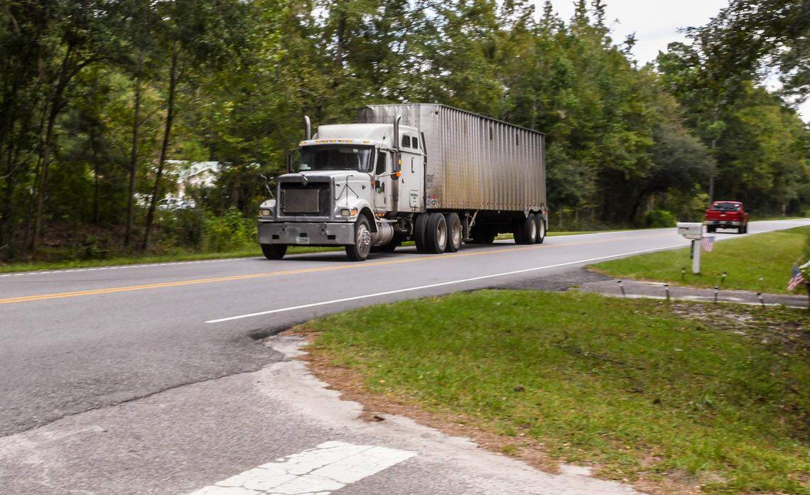 A semi carrying wood chips barrels down Timmer Road passing by the Bass Lake residential neighborhood on Sept. 24, 2020 in Ridgeland, S.C. Environmental groups claim Jasper Pellets, a wood mill tucked more than half a mile off Timmer Road, has been converting wood chips into pellets without having federal and state permits.