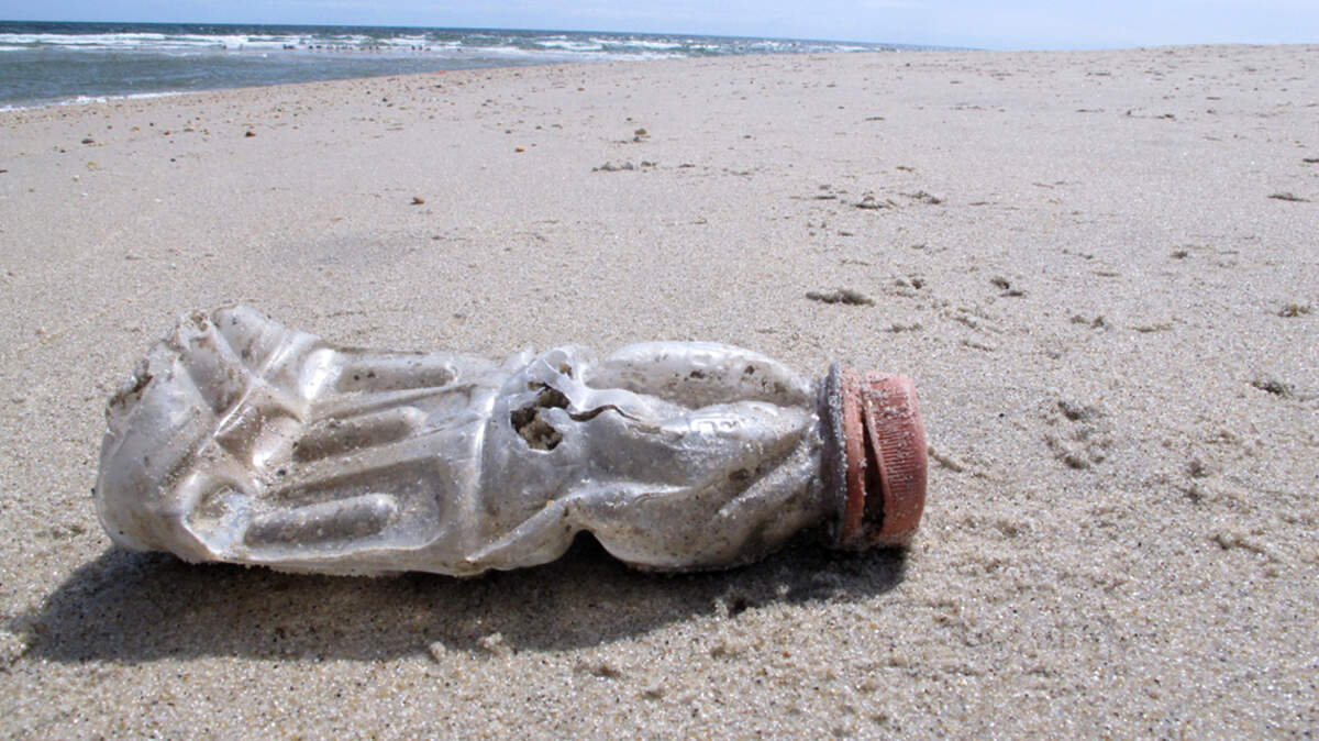 A discarded plastic bottle lies on the beach at Sandy Hook, N.J. on Tuesday, April 2, 2019, the same day as a report released by the environmental group Clean Ocean Action found that volunteers picked up more than 450,000 pieces of litter from New Jersey’s coastline last year. (AP Photo/Wayne Parry)