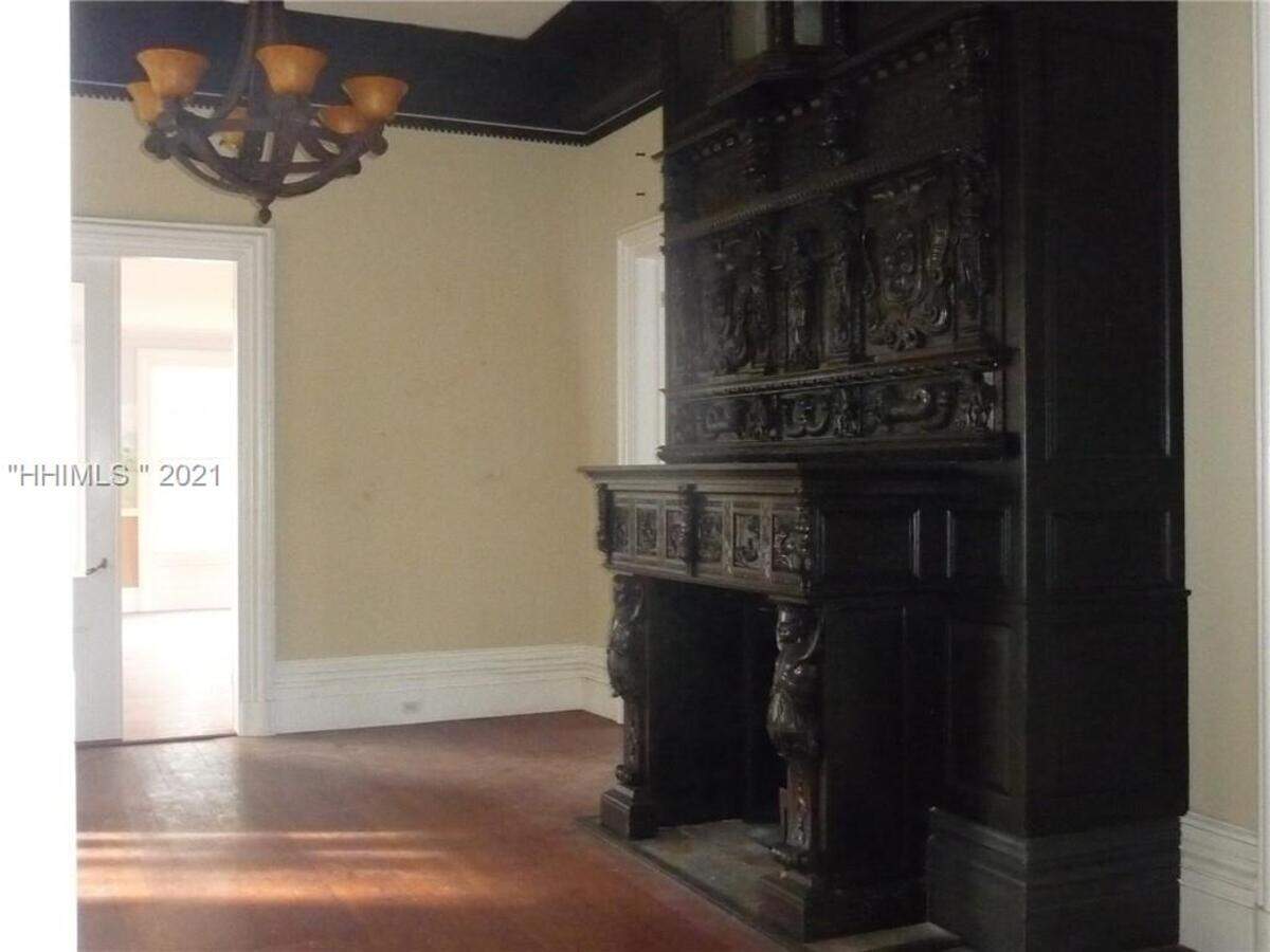 The fireplace in the family room at the Rose Hill Mansion is massive and ornately carved.