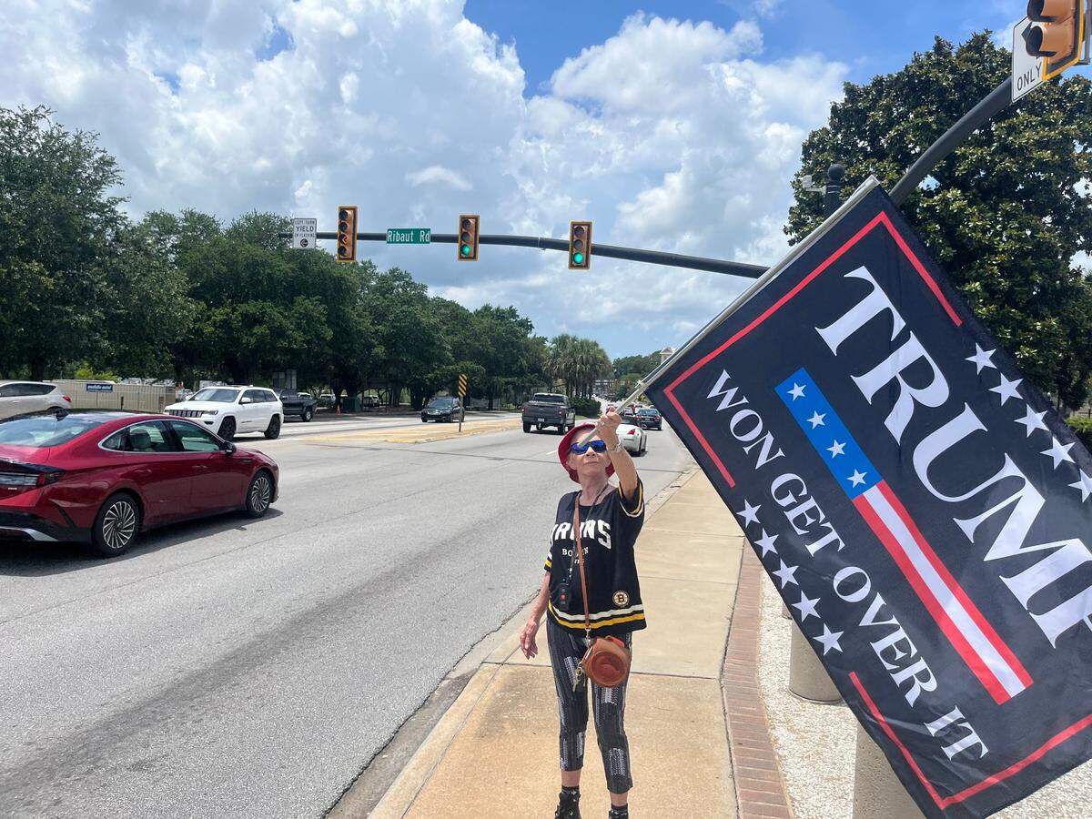 A lone Trump supporter appeared carrying a large flag that said, “Trump Won, Get Over It.”
