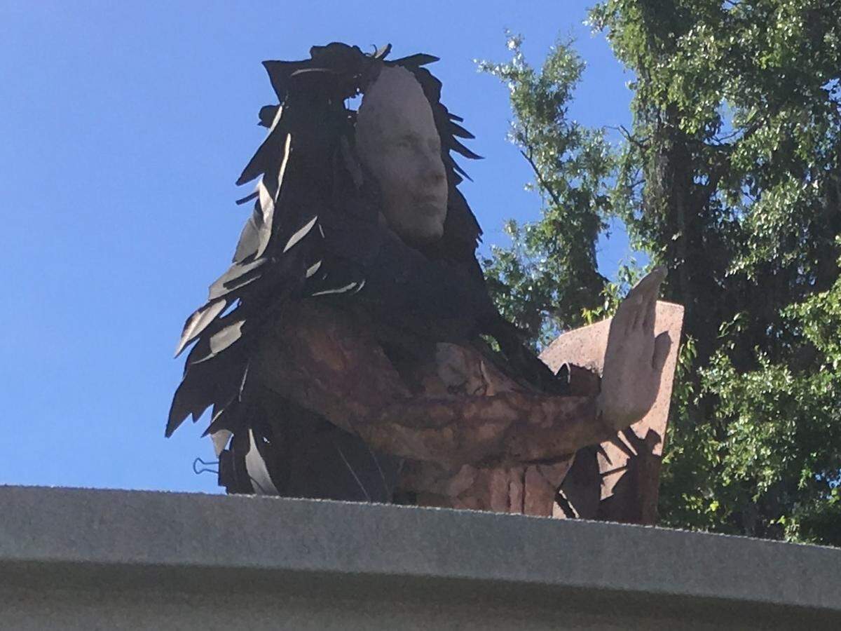 A sculpture stands behind a sign at Ribaut Road and Paris Avenue marking the entrance to the town of Port Royal. The town plans to move the sculpture and add a new logo and paint to the sign.