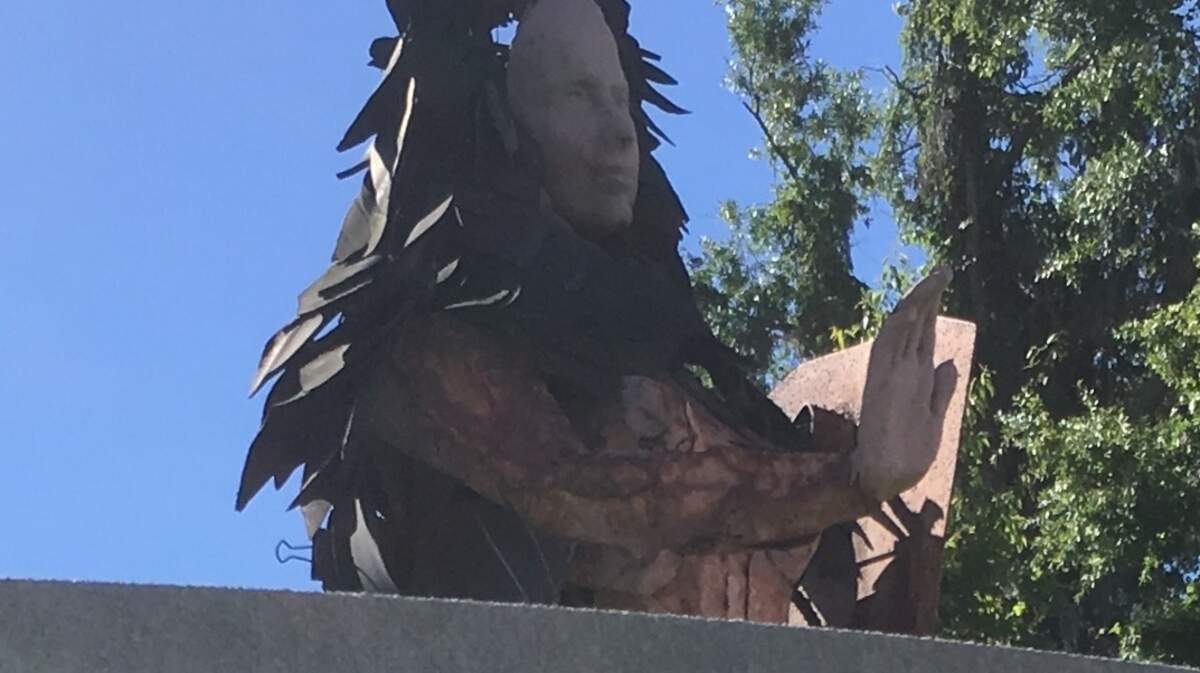 A sculpture stands behind a sign at Ribaut Road and Paris Avenue marking the entrance to the town of Port Royal. The town plans to move the sculpture and add a new logo and paint to the sign.