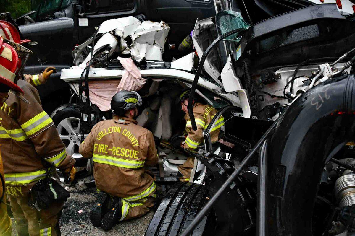 Firefighters were photographed working their way through the thick, mangled wreckage of a pileup on I-95 the afternoon of July 22, 2025 near Yemassee. Two people died and dozens others were injured in the crash, which many witnesses attributed to a sudden wave of blinding rain in the area.