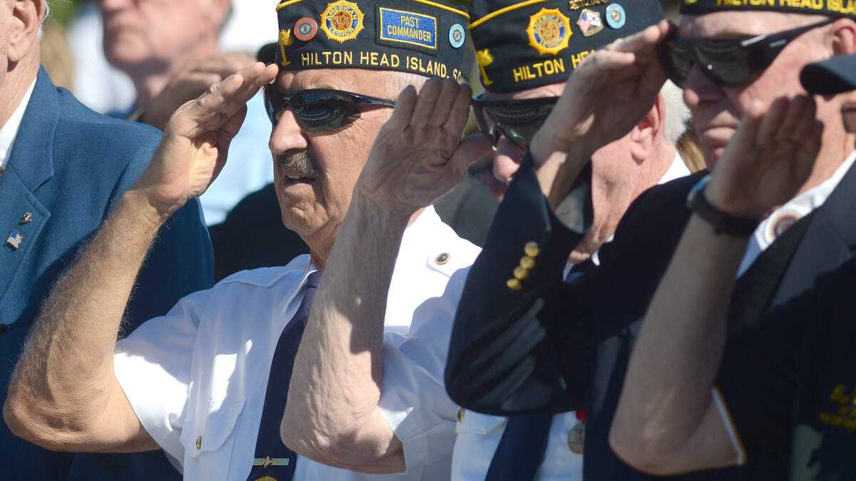 Alexander Wattay Sr., left, with American Legion Post 185 on Hilton Head Island, salutes along with other members from Post 185 as the colors are retired during the Veterans Day ceremony at Shelter Cove Veterans' Memorial Park the morning of Nov. 11, 2014, on Hilton Head Island.