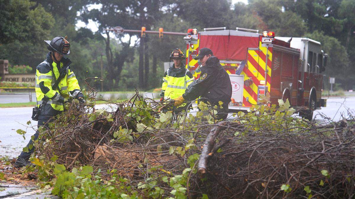 Hilton Head Island Fire Rescue from Station 5 and a officer from the Beaufort County Sheriff’s Office clear a downed tree across two-lanes on US 278 near Port Royal Plantation on Wednesday, September 4, 2019.