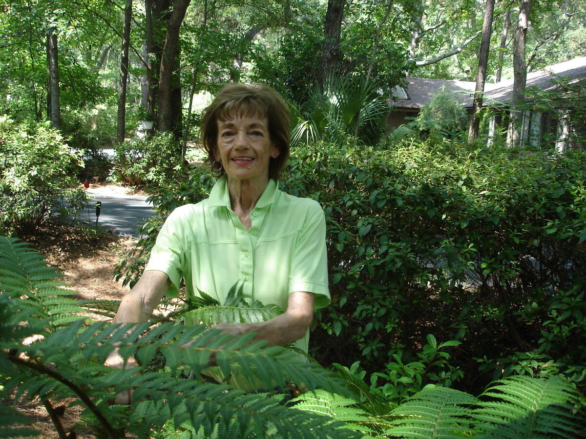Betsy Jukofsky in her plant-filled yard in Hilton Head Plantation