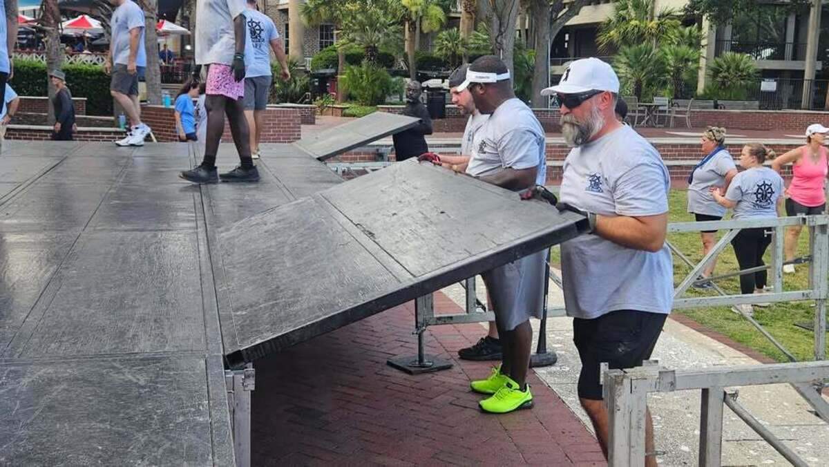Volunteers put up the stage Tuesday where music acts will be performing nightly during the Beaufort Water Festival.