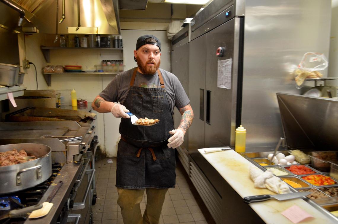 Joe Pribelsky works in the kitchen at Watusi Cafe on Friday, March 9, 2018, on Hilton Head Island, before heading to his other job as a saute cook at ELA'S Blu Water Grille.